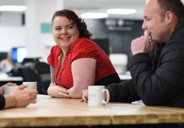 3 people at a table in conversation
