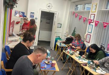Parents at a wellbeing session of arts and crafts
