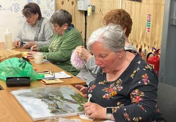 A group of women undertaking craft projects