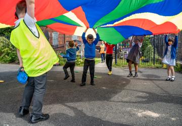 Children playing under a canopy