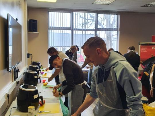 Men at a cooking session
