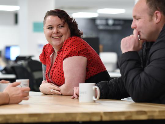 3 people at a table in conversation
