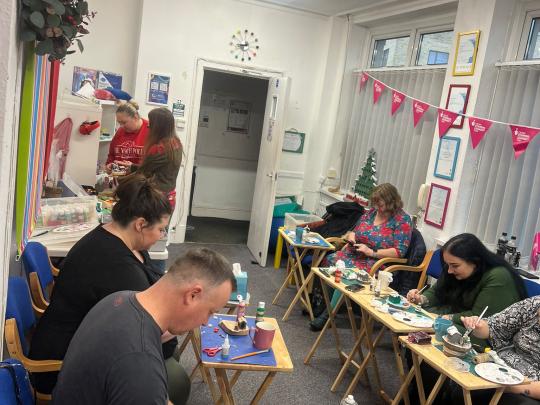 Parents at a wellbeing session of arts and crafts
